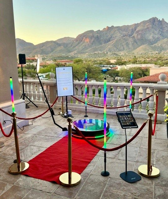 360 photo booth setup with LED light poles and red carpet at luxury resort patio, Tucson AZ